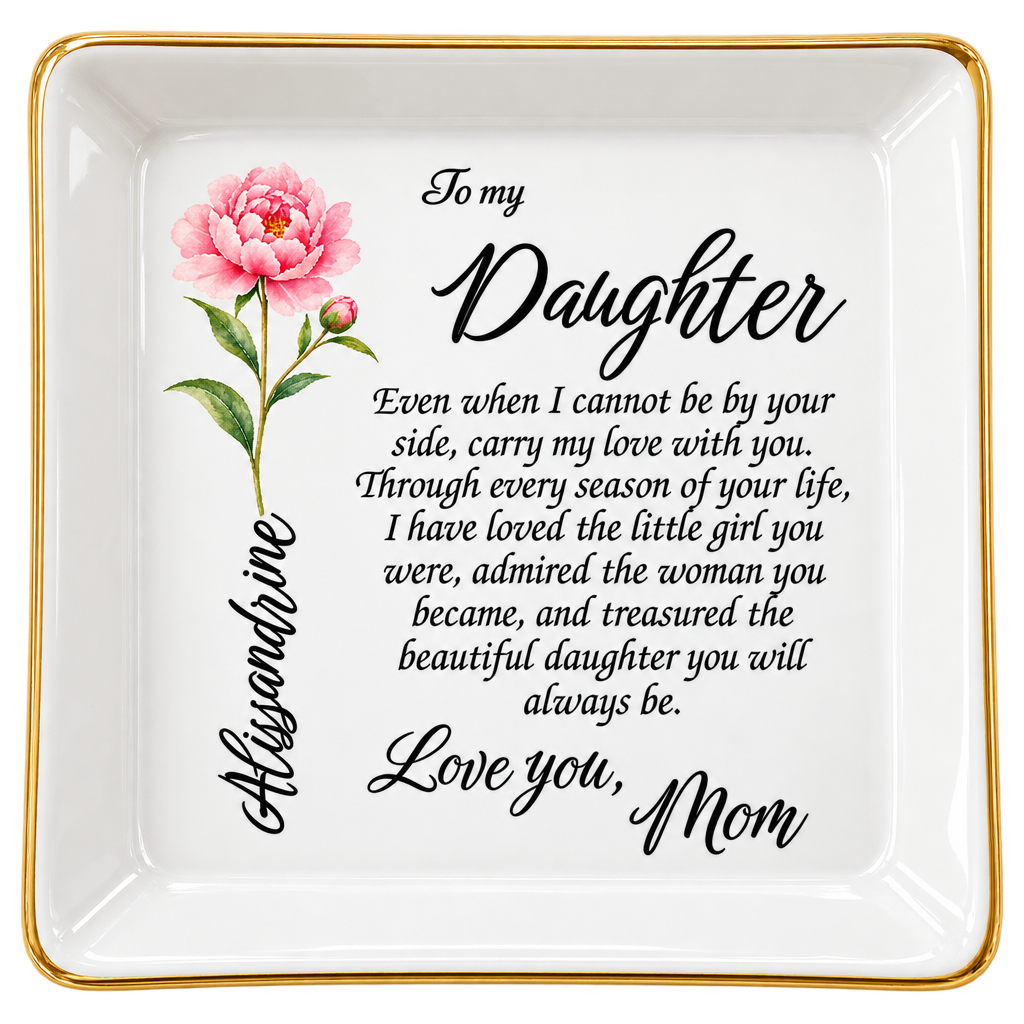 Close-up top view of a white jewelry dish with a pink peony illustration and an English To my Daughter... Love you, Mom message.